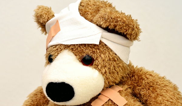 a large brown teddy bear sitting on top of a stuffed animal